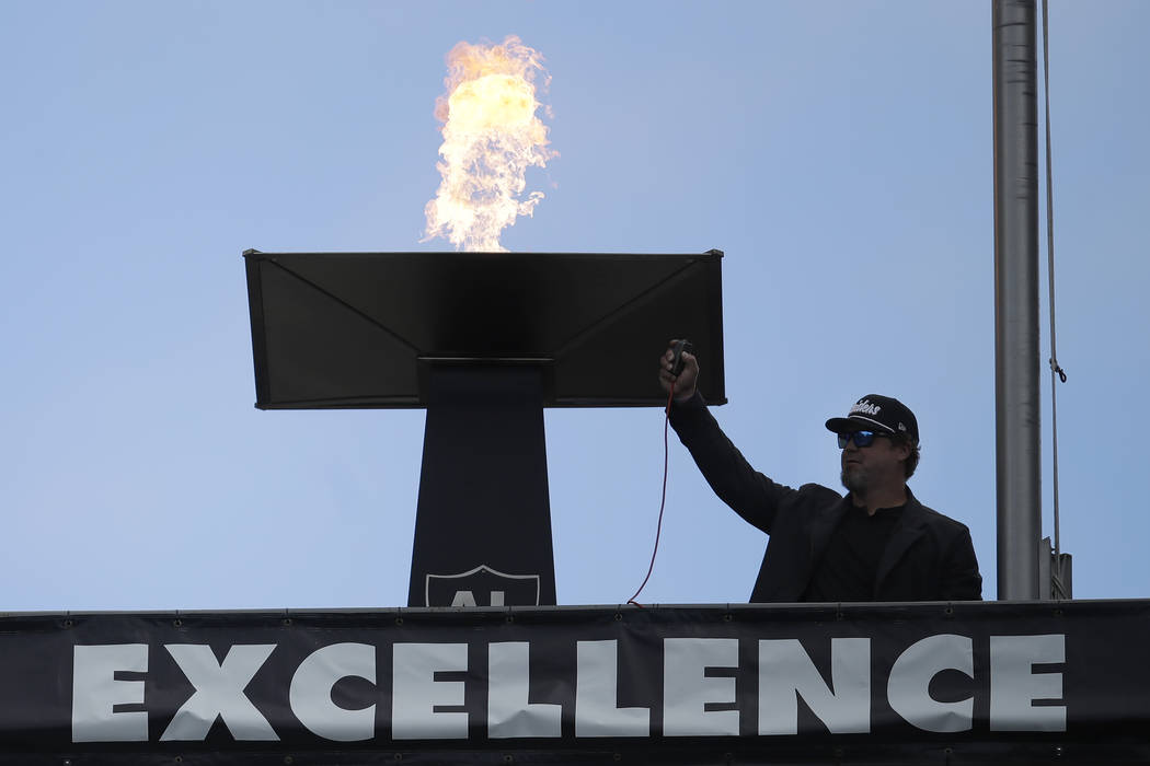 Former Oakland Raiders punter Shane Lechler lights a torch for former Raiders owner Al Davis be ...