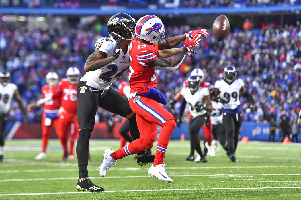 Baltimore Ravens cornerback Marcus Peters (24) breaks up a pass intended for Buffalo Bills wide ...