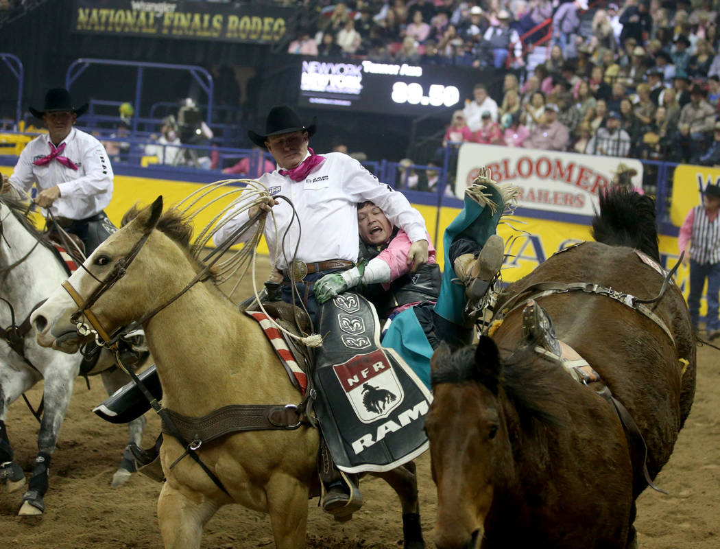 Tanner Aus of Granite Falls, Minn. dismounts Weenie in the bareback competition during the fift ...