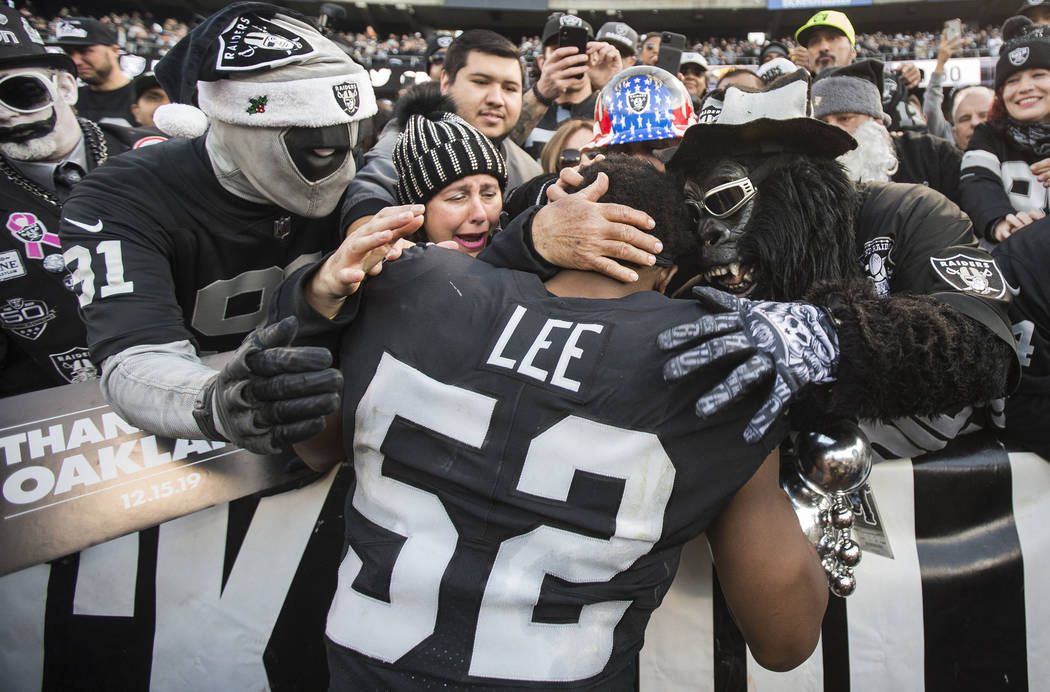 Oakland Raiders middle linebacker Marquel Lee (52) hugs fans in the "Black Hole" afte ...