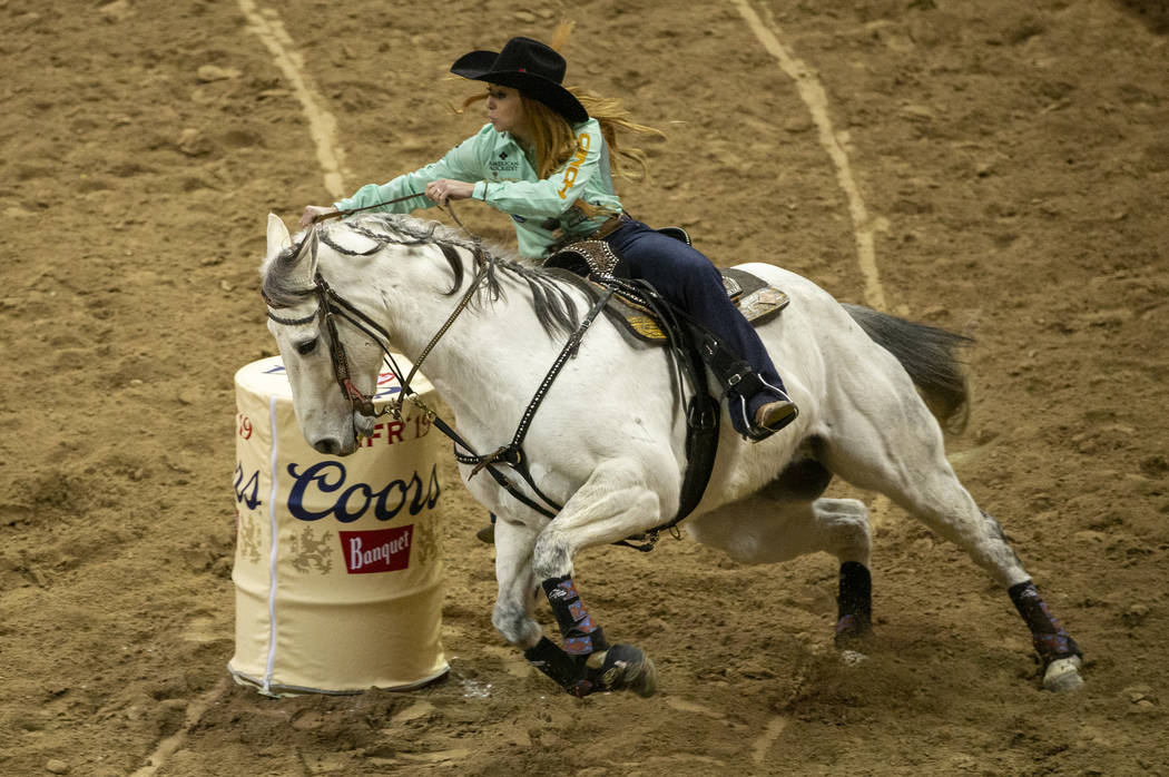 Emily Miller of Weatherford, Okla., turns the corner on her way to a time of 13.64 seconds and ...