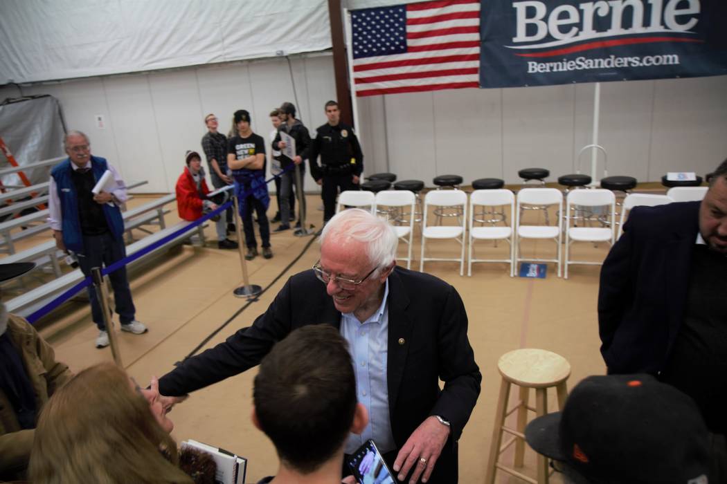 Vermont Sen. Bernie Sanders speaking with members of the crowd after a campaign event in Carson ...