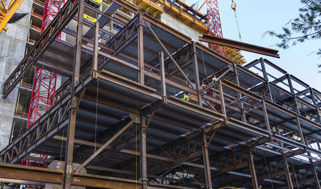 Workers ready to secure another beam being brought up during a construction tour of the Circa o ...