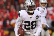 Oakland Raiders running back Josh Jacobs (28) holds on to the football after a run during the f ...