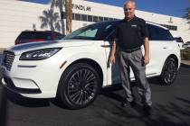 Findlay Lincoln sales consultant Jeff Lamper is seen with a 2020 Lincoln Corsair sport utility ...