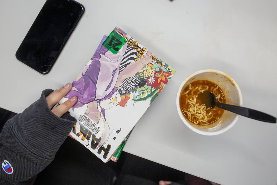 Nicole Valenzuela, 12, holds her stack of anime novels at the East Las Vegas Library in Las Veg ...