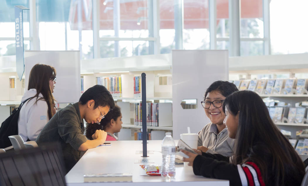 Individuals read and talk at the East Las Vegas Library in Las Vegas on Tuesday, Dec. 10, 2019. ...