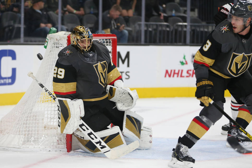 Vegas Golden Knights goaltender Marc-Andre Fleury (29) makes a save as defenseman Brayden McNab ...