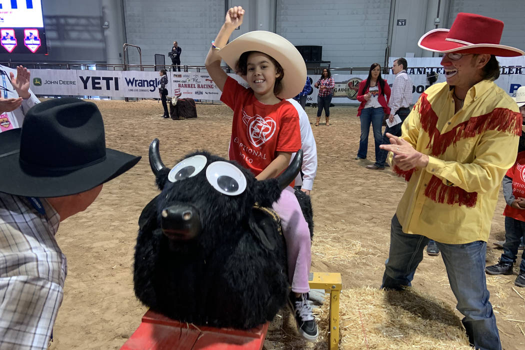 Tiana Turner keeps her right arm up in displaying perfect form while riding the rocking bull du ...