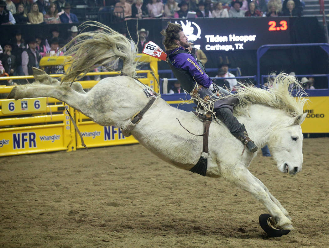 Tilden Hooper of Carthage, Texas rides Virgil during Bareback Riding in the fifth go-around of ...