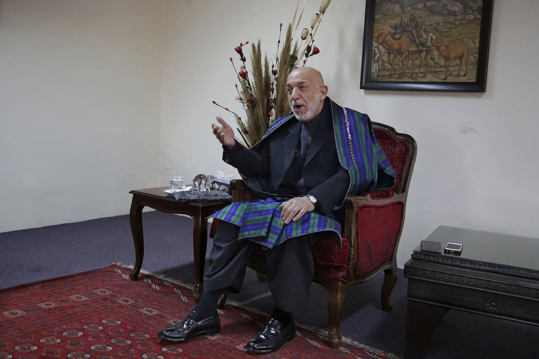 Former Afghan President Hamid Karzai gestures while speaking during an interview with The Assoc ...