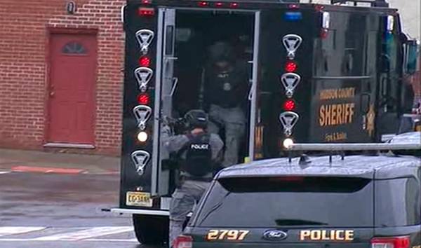 In this image taken from video, Hudson County Swat team officers arrive at the scene following ...