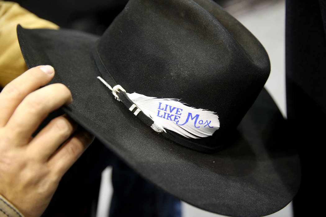 Steer wrestler Riley Duvall dons a "Live Like Max" white before the sixth go-round of ...