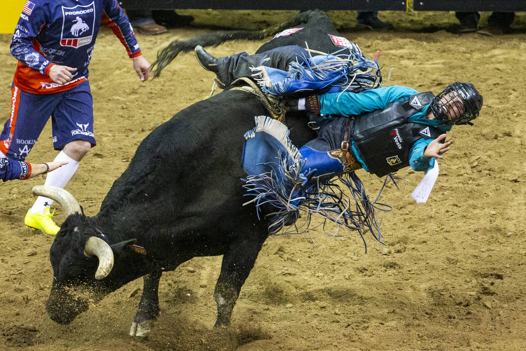 Tyler Bingham of Honeyville, Utah, gets sideways on Night Moves in Bull Riding during the fourt ...