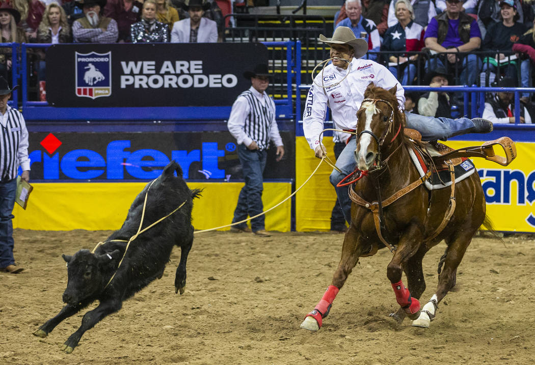 Shad Mayfield of of Clovis, N.M., eyes a roped calf in Tie-Down Roping during the sixth go roun ...