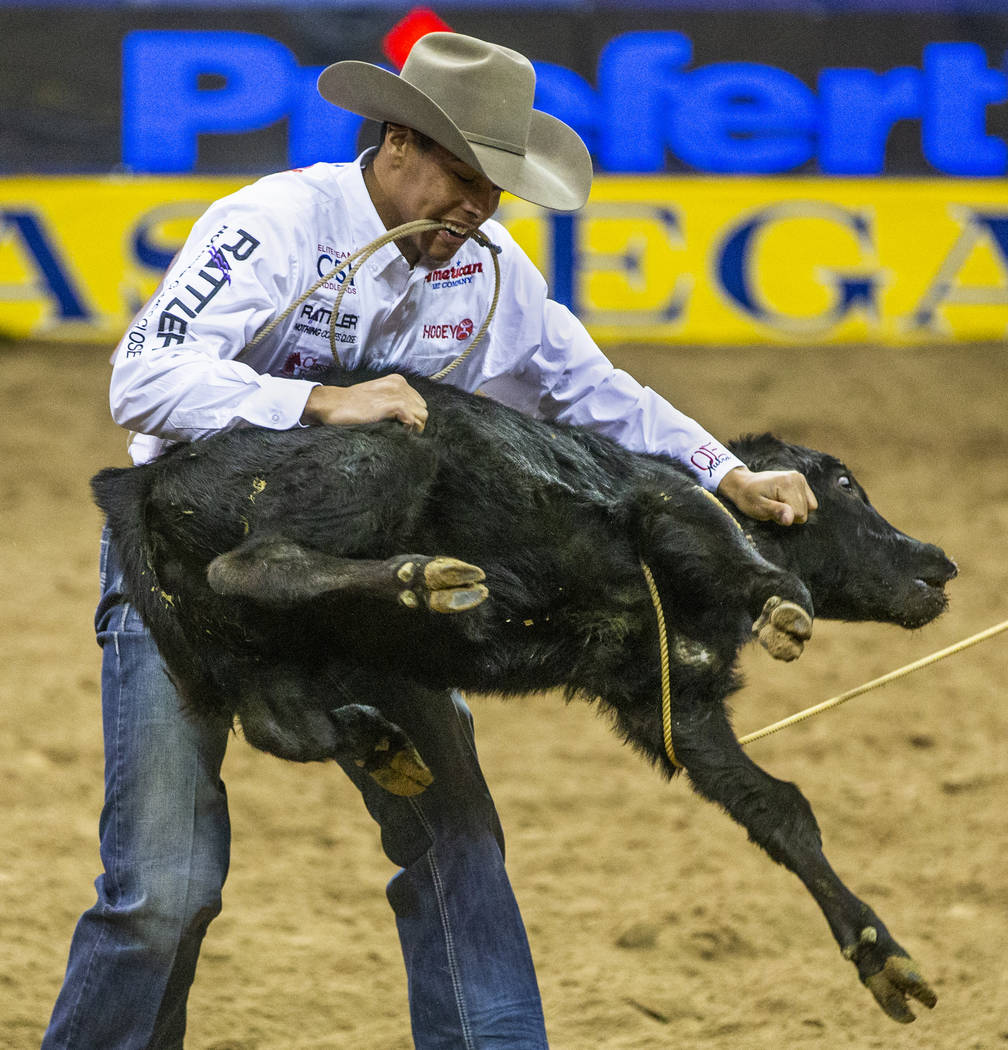 Shad Mayfield of of Clovis, N.M., tosses a roped calf in Tie-Down Roping during the sixth go ro ...