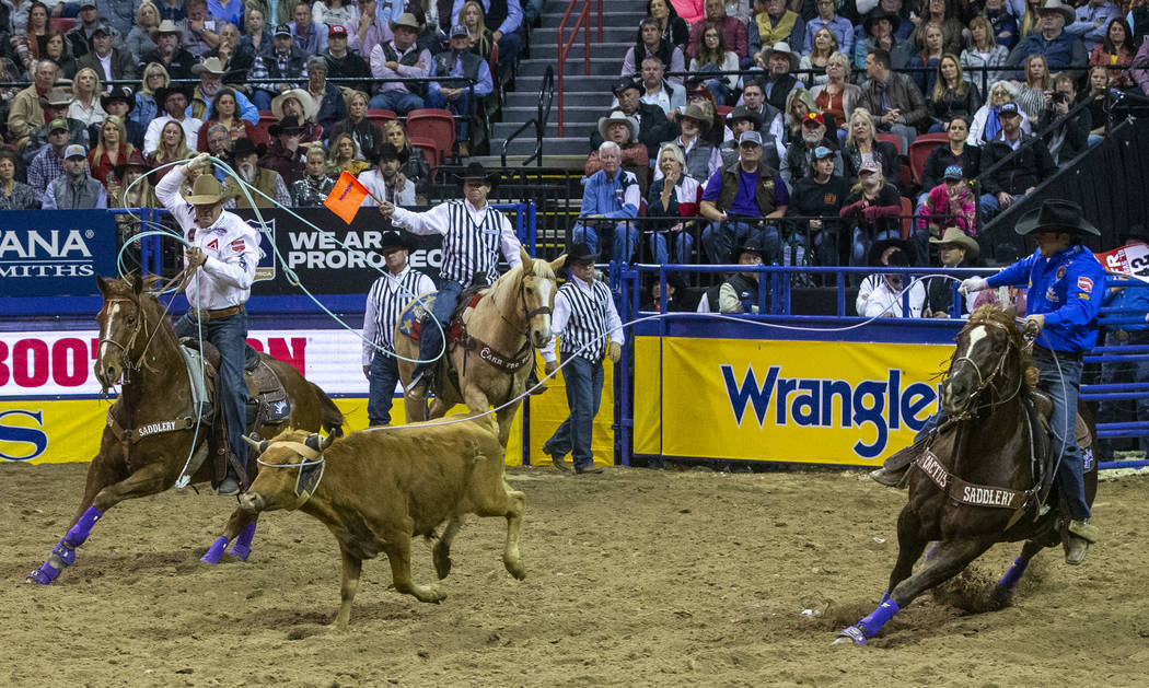 Heeler Brady Minor, left, and Header Riley Minor, both of Ellensburg, Wash., work together on T ...