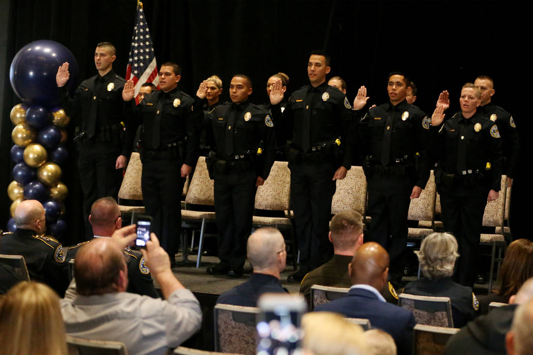 Police academy recruits are sworn in as officers during a graduation ceremony in Henderson Poli ...