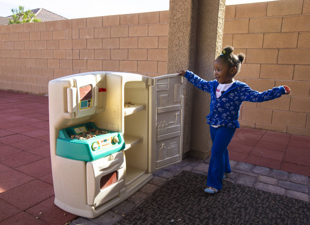 Christine Modica, 3, plays with a toy kitchen set at the home she shares with her great-aunt, L ...