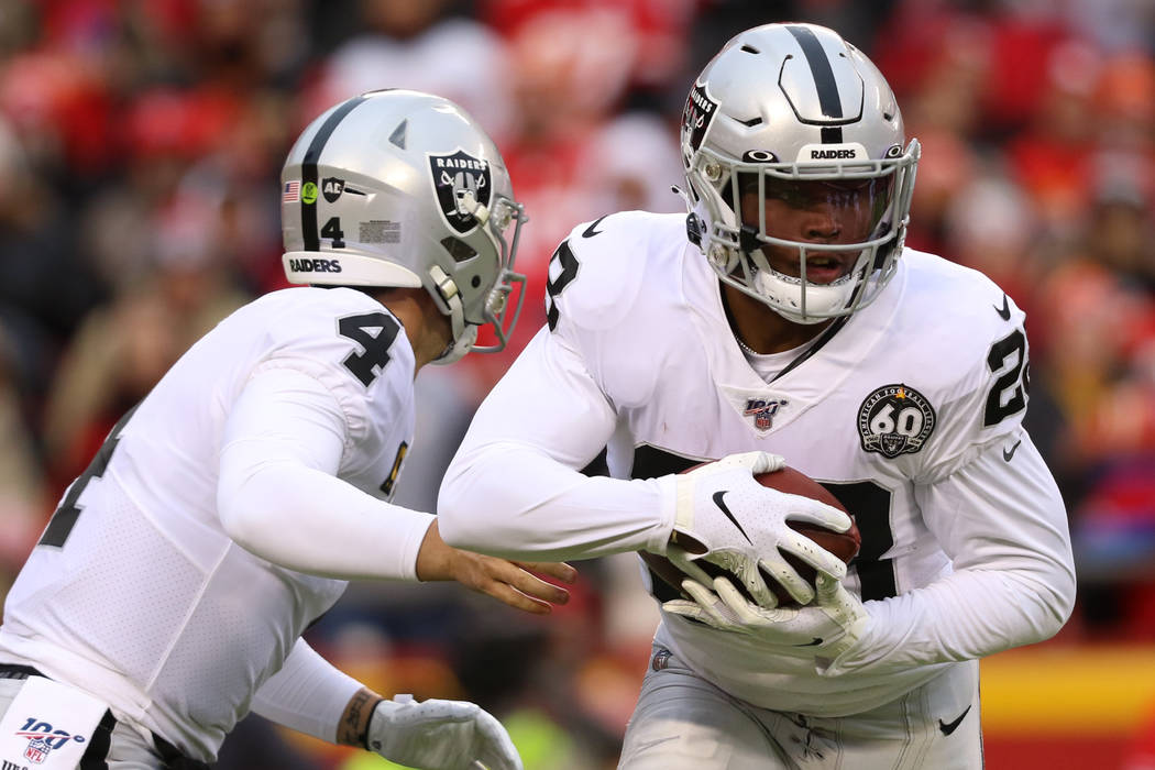 Oakland Raiders quarterback Derek Carr (4) hands off the football to running back Josh Jacobs ( ...