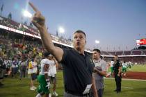 Oregon head coach Mario Cristobal points to fans as he walks off the field after an NCAA colleg ...