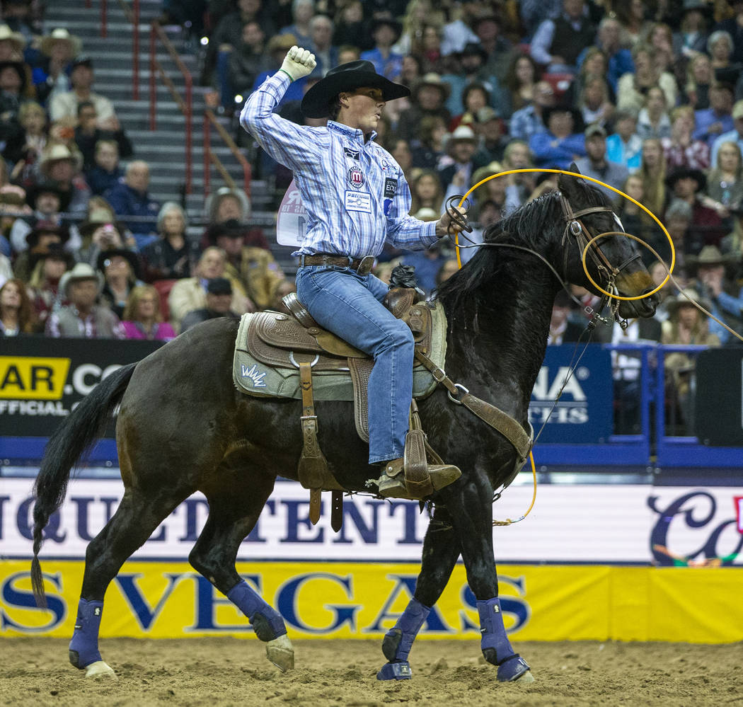 Heeler Wesley Thorp of Throckmorton, Texas, celebrates a first place time of 3.60 seconds with ...