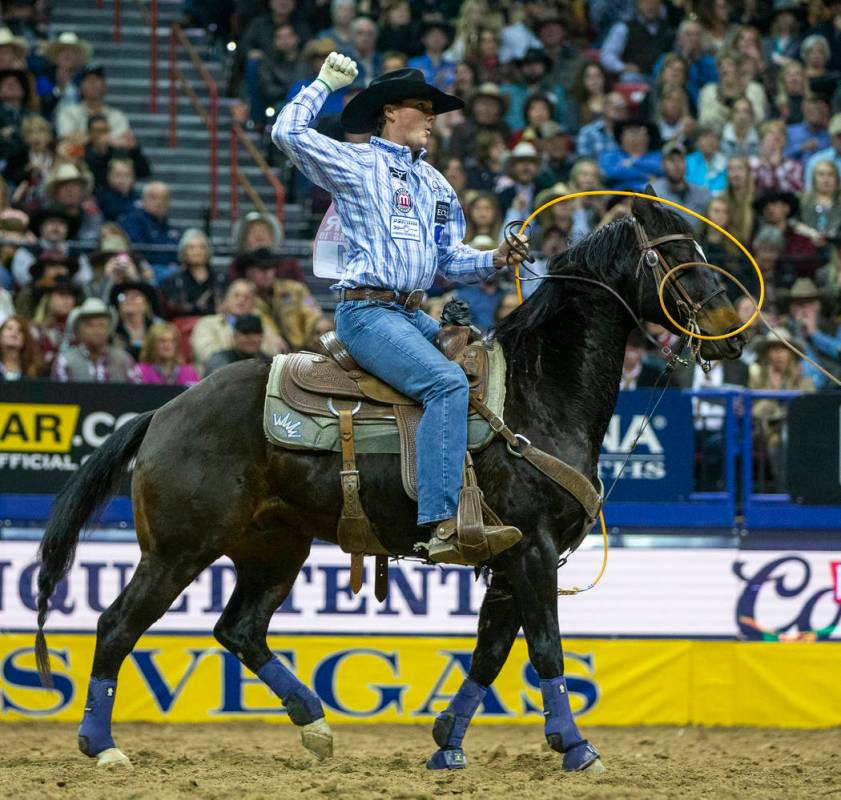 Heeler Wesley Thorp of Throckmorton, Texas, celebrates a first place time of 3.60 seconds with ...