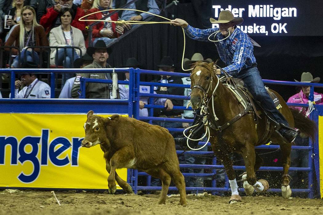 Tyler Milligan of Pawhuska, Okla., eyes a calf while on a first place time of 7.50 seconds in T ...