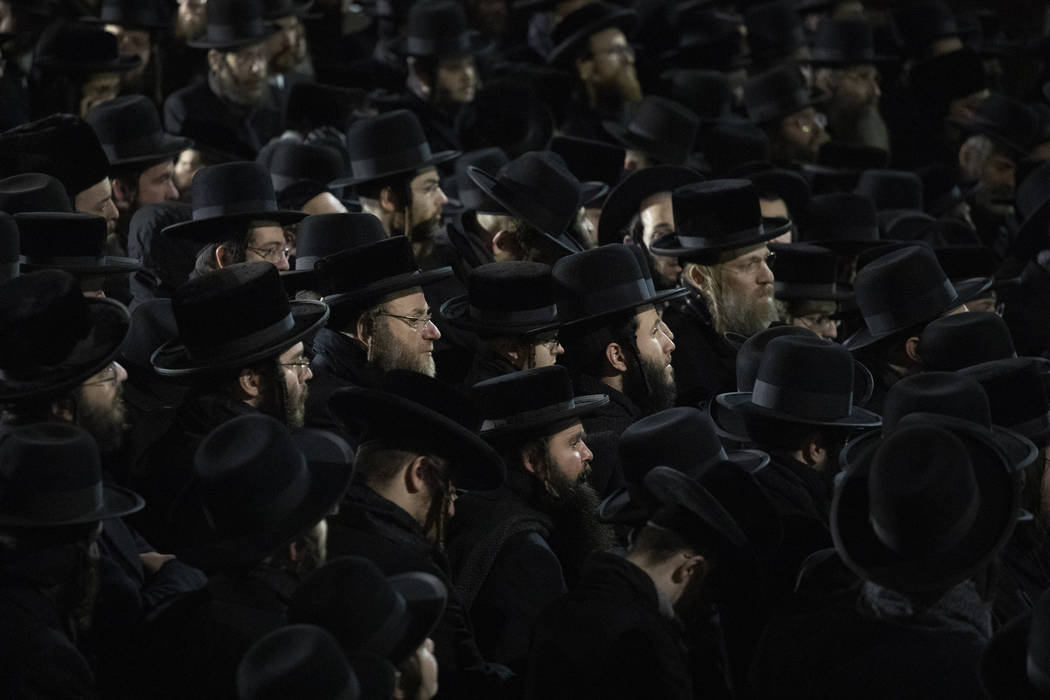 Orthodox Jewish men attend Moshe Deutsch's funeral, Wednesday, Dec. 11, 2019 in the Williamsbur ...