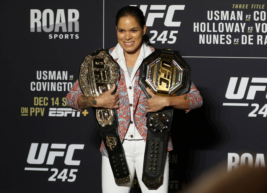 UFC women's two-division champion Amanda Nunes poses with her belts during a UFC 245 media even ...