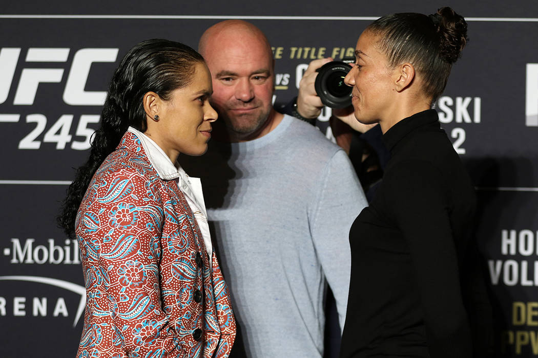 UFC women's two-division champion Amanda Nunes faces off with Germaine de Randamie, right, duri ...