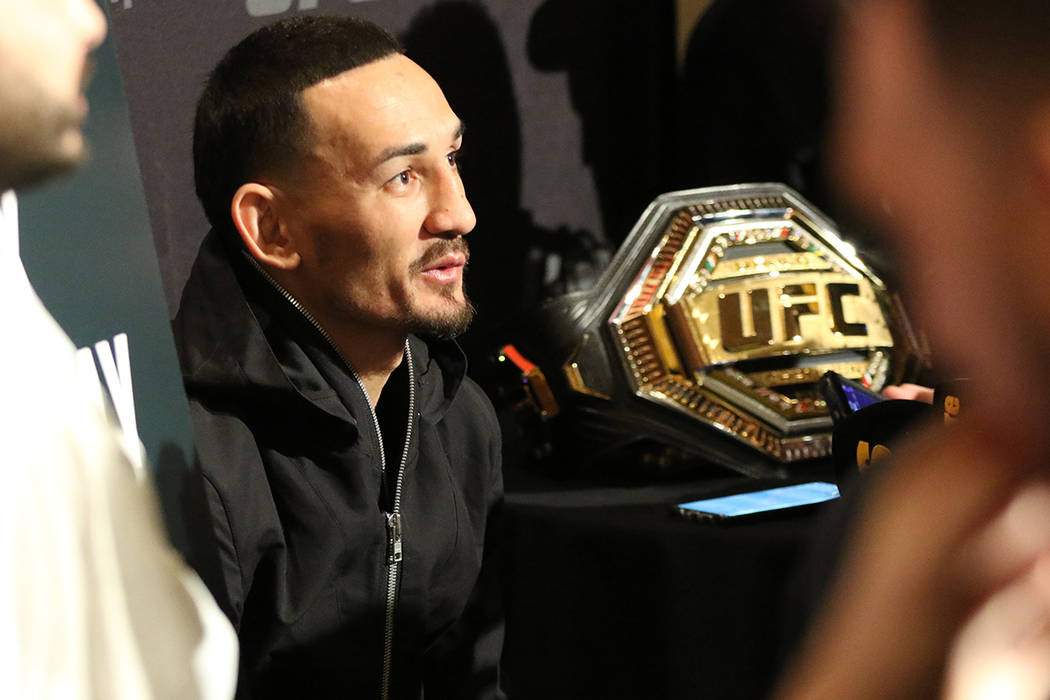 UFC featherweight champion Max Holloway answers questions from reporters during a UFC 245 media ...