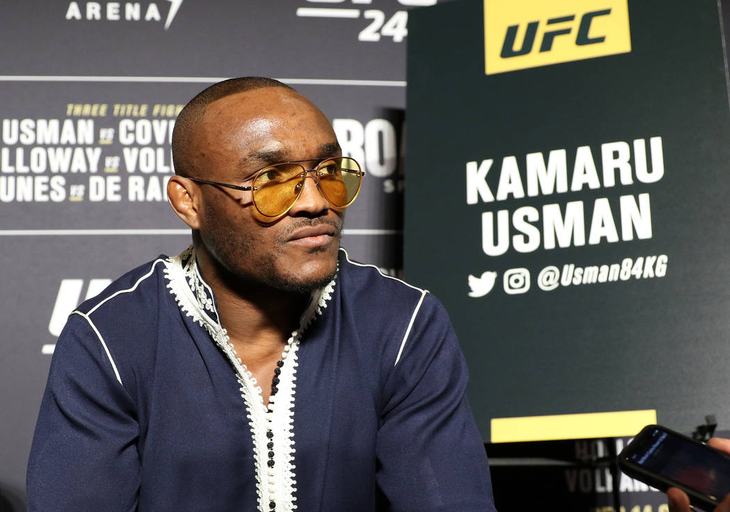 UFC middleweight champion Kamaru Usman fields questions from reporters during a UFC 245 media e ...