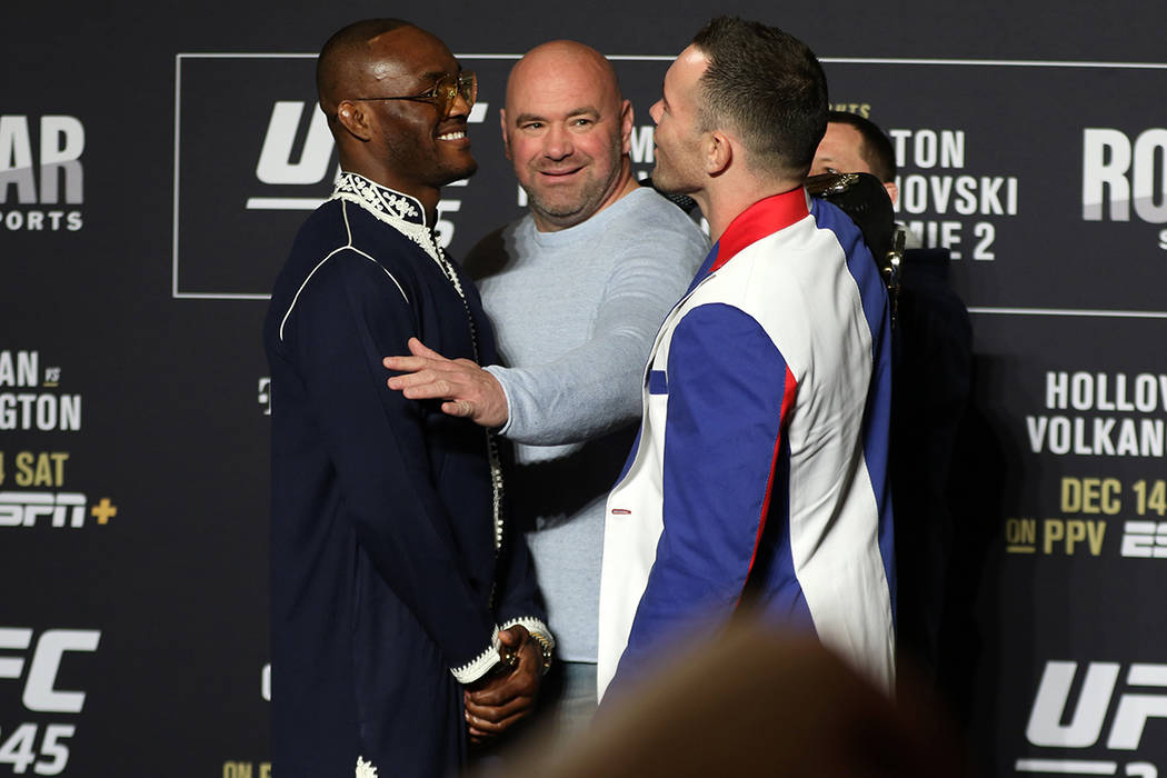 UFC welterweights Kamaru Usman and Colby Covington, right, engage in a face off as UFC presiden ...