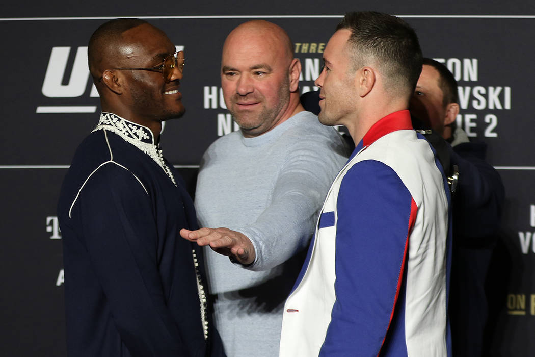 UFC welterweights Kamaru Usman and Colby Covington, right, engage in a face off as UFC presiden ...