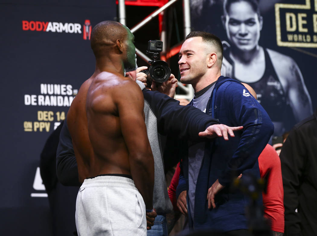 Kamaru Usman, left, and Colby Covington face off during the ceremonial weigh-in event ahead of ...