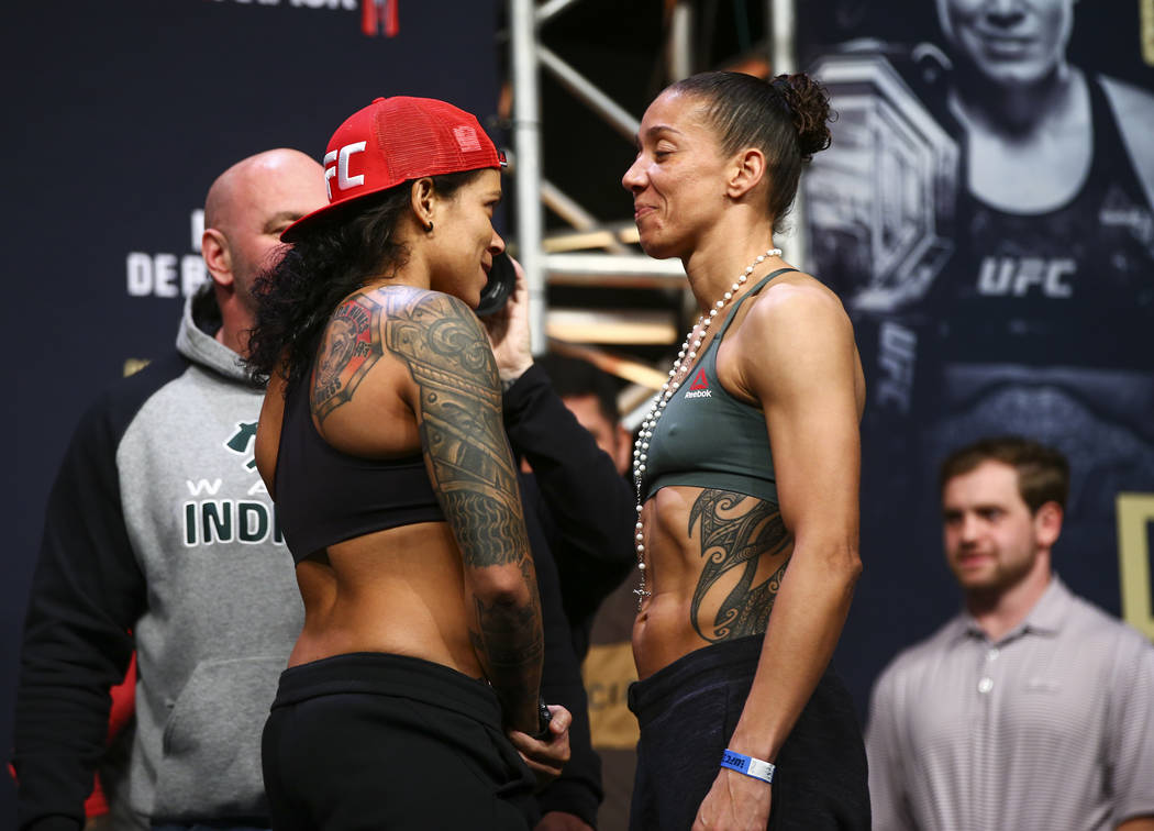 Amanda Nunes, left, and Germaine de Randamie face off during the ceremonial weigh-in event ahea ...