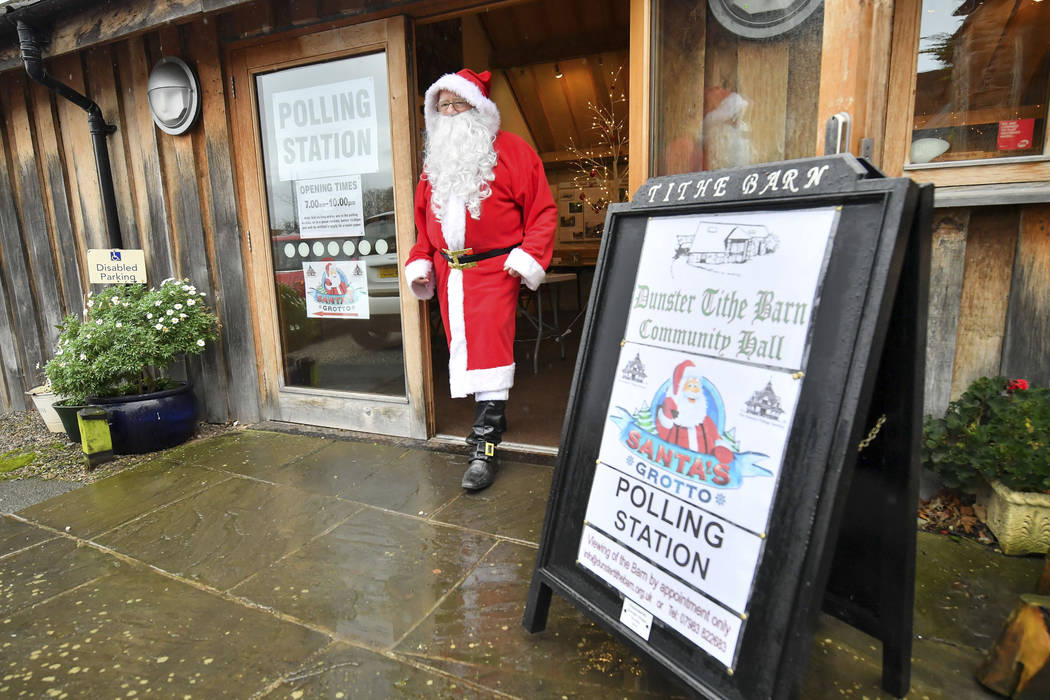 A man dressed as Father Christmas walks from his grotto at the Dunster Tithe Barn near Minehead ...