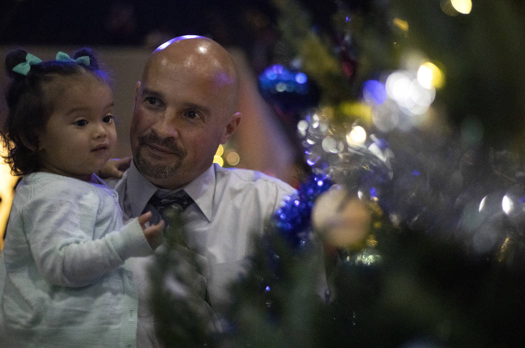 Chris Ritenour of Virginia, who is an inmate at Casa Grande Transitional Housing, holds his dau ...