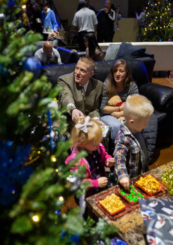 Robert Brackeen, left and Carsen Brackeen, right, hang out on their "living room" couch with th ...