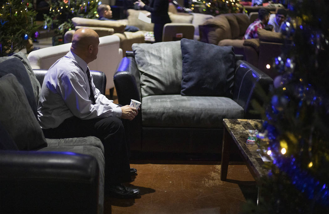 Chris Ritenour waits for his family to arrive as he watches other inmates' loved ones file in a ...