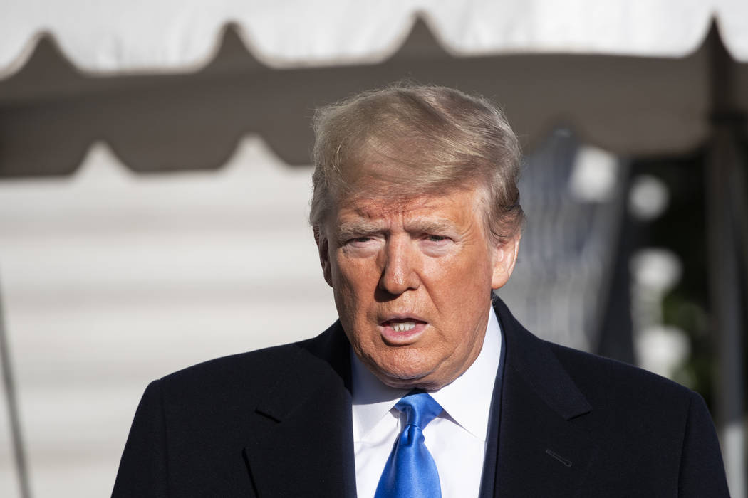 President Donald Trump speaks with reporters before boarding Marine One on the South Lawn of th ...