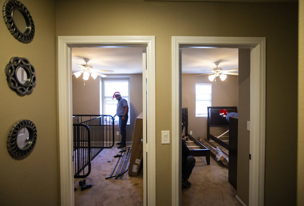 Walker Furniture employee Cole, who declined to give his last name, helps set up furnishings fo ...