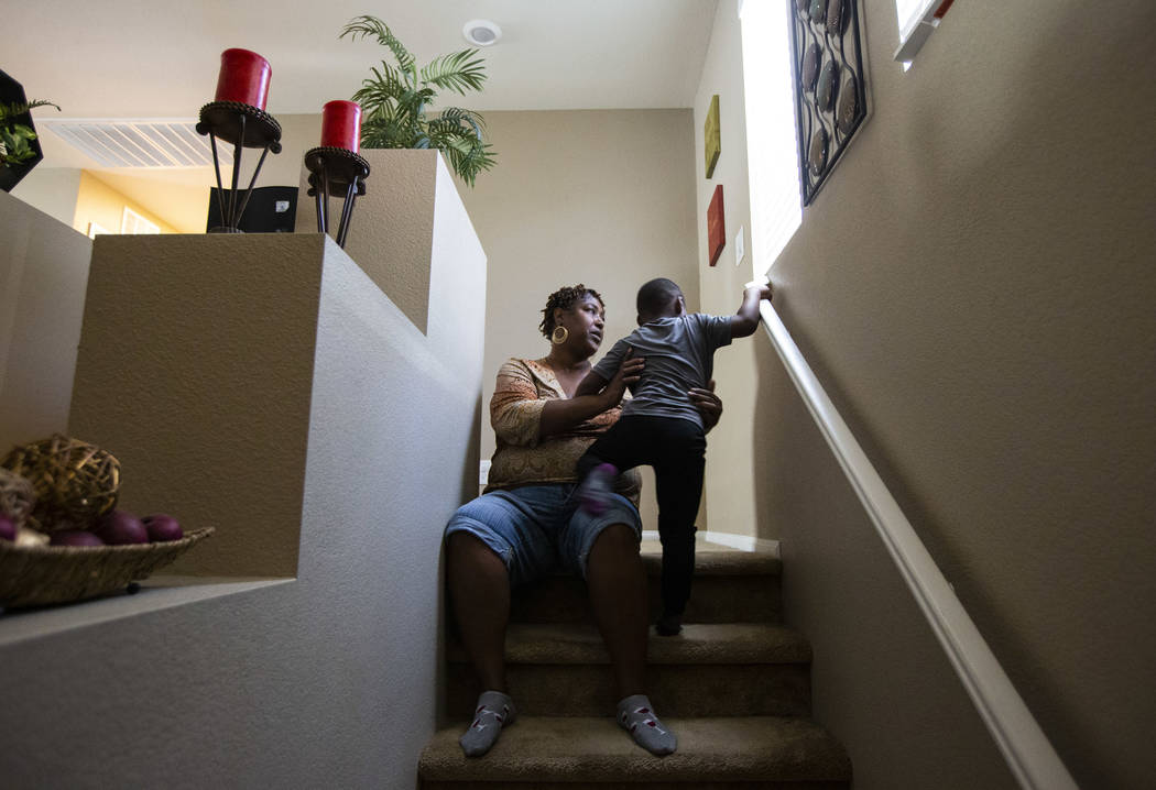 Lucille McKnight sits for a moment with her great-nephew, Noel Modica, 4, as employees from Wal ...