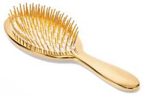 Handcrafted in Italy, AERIN's classic hairbrush features gold-tipped ivory bristles. aerin.com
