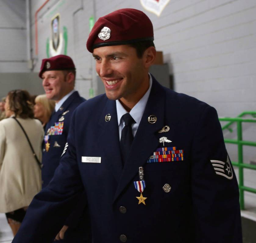 Staff Sgt. Daniel Swensen, greets a member of the military after a ceremony awarding the Silver ...