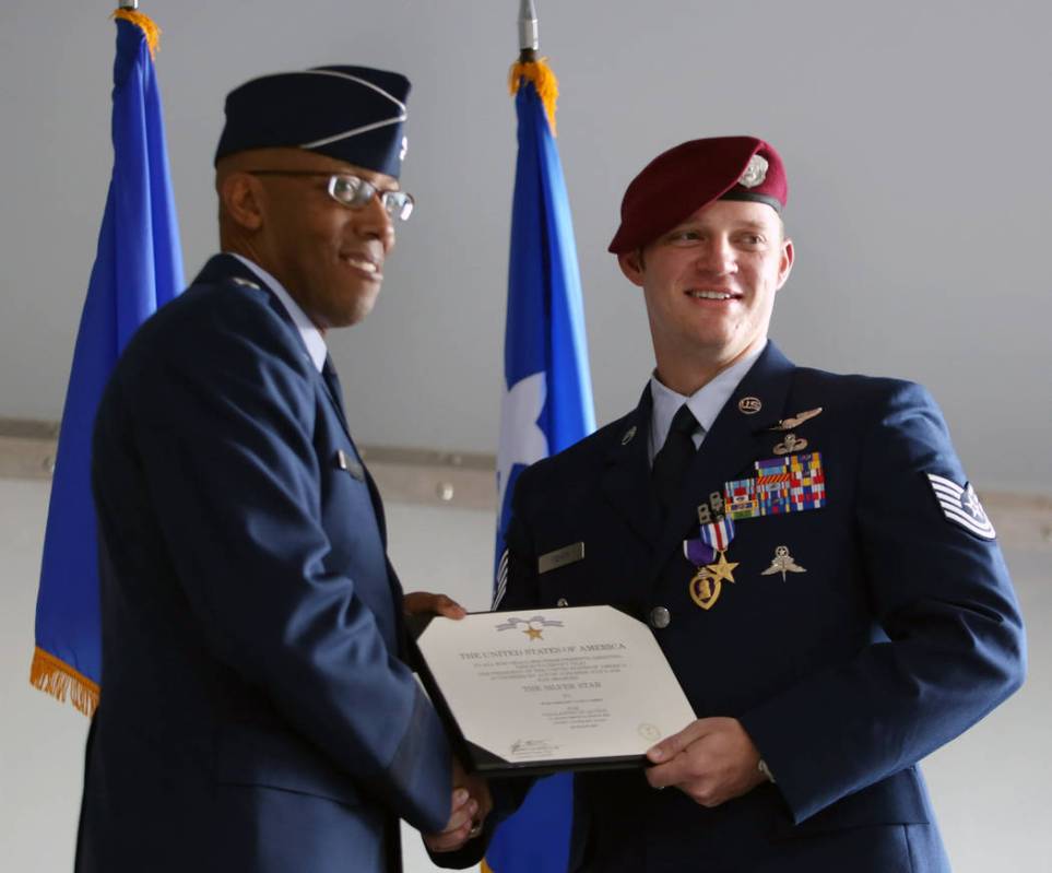 Gen. Charles Brown Jr., left, and Technical Sgt. Gavin Fisher shake hands during a ceremony awa ...