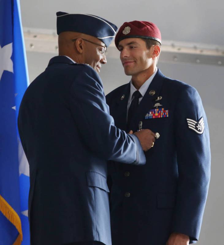 Gen. Charles Brown Jr., left, pins on the Silver Star Medal onto Staff Sgt. Daniel Swensen at N ...