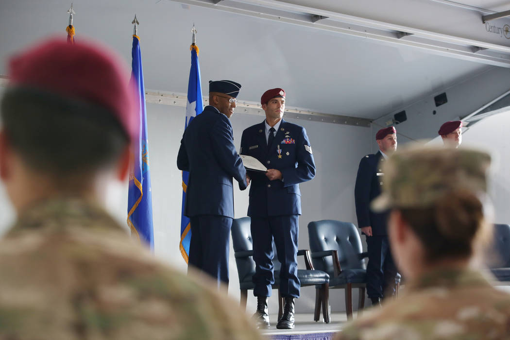 Gen. Charles Brown Jr., left, and Staff Sgt. Daniel Swensen hold Sgt. Swensen's certificate of ...