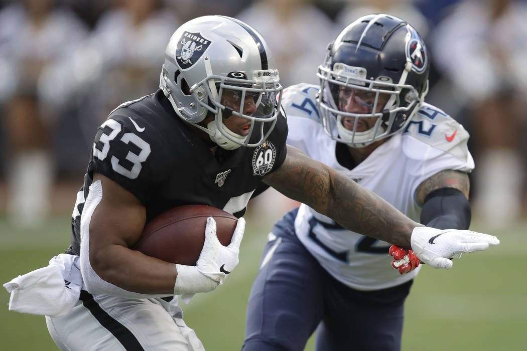 Oakland Raiders running back DeAndre Washington (33) runs for a touchdown past Tennessee Titans ...